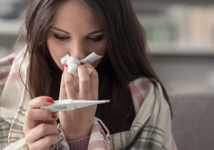 sick woman checking temperature